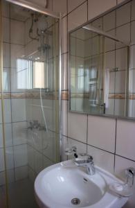 a bathroom with a sink and a mirror at Kunta Kinte Hotel in Accra