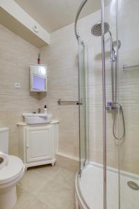 a bathroom with a shower and a toilet and a sink at Loft proche PARIS SAINT-LAZARE in Courbevoie