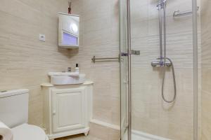a bathroom with a shower and a toilet and a sink at Loft proche PARIS SAINT-LAZARE in Courbevoie