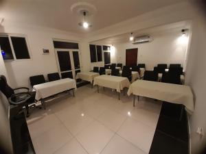 a conference room with chairs and tables in a room at Kunta Kinte Hotel in Accra