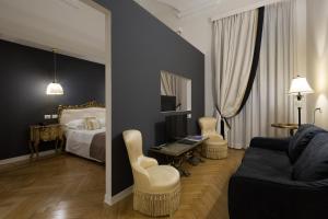 a hotel room with a bed and a desk and chair at Mediterraneo Emotional Hotel & Spa in Santa Margherita Ligure