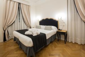 a bedroom with a large bed with a black headboard at Mediterraneo Emotional Hotel & Spa in Santa Margherita Ligure