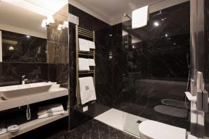 a black bathroom with a sink and a shower at Mediterraneo Emotional Hotel & Spa in Santa Margherita Ligure