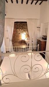 a bedroom with a bed and a brick wall at Casina di Alice in Vinci