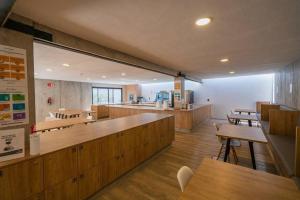 a restaurant with wooden counters and tables and benches at +MS +Loft Coworking +Vigilancia 24hrs +Internet 504 in Laborcillas