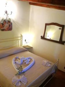 ein Schlafzimmer mit einem Bett mit einem aus Band gefertigten Herz in der Unterkunft Casa Vacanze 'Al Giardino degli Ulivi' in Marinella di Selinunte