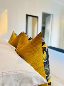 A bed or beds in a room at Nal'enzo Luxe Stays