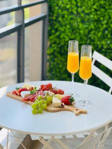 deux verres de jus d'orange et de fruits sur une table dans l'établissement Nal'enzo Luxe Stays, à Johannesbourg