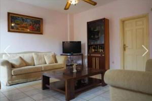 a living room with a couch and a coffee table at George 's Nest in Áyios Spirídhon