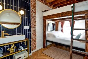 a bedroom with a bunk bed and a sink and a mirror at HighRoad Washington DC in Washington, D.C.