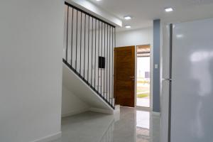 a hallway with white walls and a wooden door at Hotel Cantera Respira Campo in Potrero de los Funes