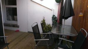 a table and chairs and an umbrella in a room at Wexford Town Apartment in Wexford