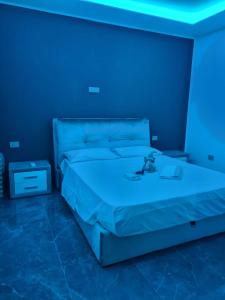 a bedroom with a bed with a blue light at il ruggito del leone in Verona
