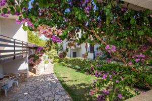 a garden with pink flowers on a building at Apartments with parking space Pjescana Uvala, Pula - 7349 in Pula