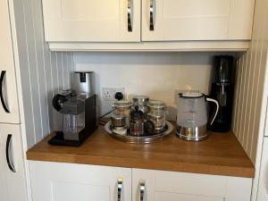 a kitchen counter with a coffee maker and a blender at Sea Facing 2BD Terraced Home - Peacehaven in Peacehaven