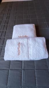 two white towels sitting on a tile floor at Valle Florido 2 in Trevelin