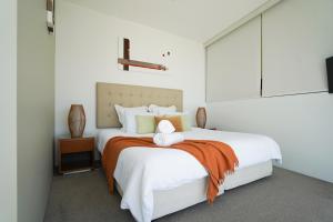 a bedroom with a bed with a cross on the wall at Air On Broadbeach-Amazing Ocean Views in Gold Coast