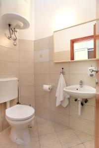 a bathroom with a toilet and a sink at Apartments with a parking space Okrug Gornji, Ciovo - 19713 in Trogir