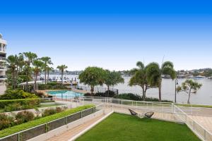 a view of the water from the balcony of a resort at Stylish Riverside Retreat - New Farm in Brisbane