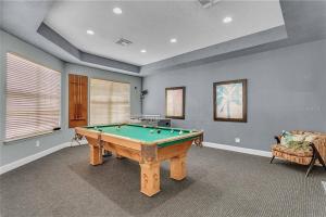 a room with a pool table and a couch at COZY Condo - Perfect Location Close to Disney in Kissimmee