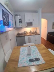 a small kitchen with a table with a remote control on it at Apart los Lirios in Salta