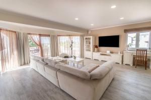 a large living room with a large couch and a tv at Apartments for families with children Banjol, Rab - 19804 in Rab