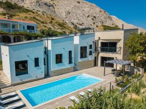 a house with a swimming pool in front of it at Luxury villa with a swimming pool Bosana, Pag - 19824 in Pag