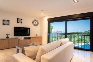 a living room with a couch and a television at Luxury villa with a swimming pool Bosana, Pag - 19824 in Pag