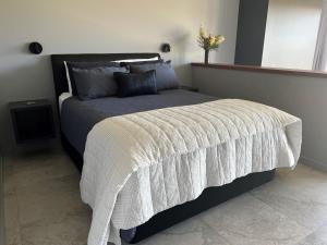 a bedroom with a large bed with a white blanket at 145 Western Adults ONLY in Montville