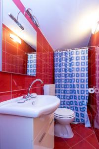 a bathroom with a white sink and a toilet at Apartments by the sea Tkon, Pasman - 19913 in Tkon