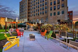 a patio with colorful chairs and tables in front of a building at Elegant Main Street Living* Near NYC in Hackensack