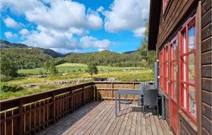 a wooden deck with a table and chairs on it at 3 Bedroom Amazing Home In Vikes in Vikeså