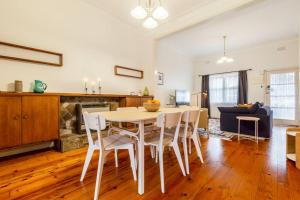 a kitchen and living room with a table and chairs at Comfortable Richmond home - Melbourne’s best location in Melbourne