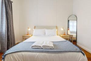 a bedroom with a bed with two towels on it at Comfortable Richmond home - Melbourne’s best location in Melbourne