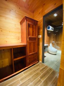 a bathroom with a toilet and a sink in a room at Berry Valley Homestay in Da Lat
