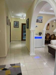 a large living room with a couch and an archway at Janha's Senegambia Villa Holiday Rental With Free Wifi in Amdalai