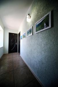 a hallway with a wall with pictures on it at Hotel Kutaisi Globus in Kutaisi