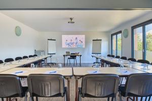 a classroom with rows of tables and chairs at Kyriad Direct Strasbourg Ouest - Zénith in Strasbourg