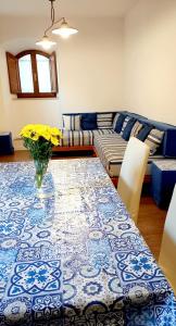 een woonkamer met een tafel met een vaas met bloemen bij Casa "ALCENTRO" in Assisi