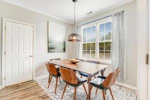 a dining room with a table and chairs and a window at Sandpiper Village --- 35552 E Atlantic Cir #101 in Rehoboth Beach