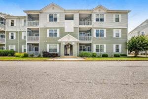 a large apartment building with a front door at Sandpiper Village --- 35552 E Atlantic Cir #101 in Rehoboth Beach