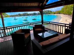a balcony with a view of the water and boats at Grand Baie Beach Penthouse in Grand Baie