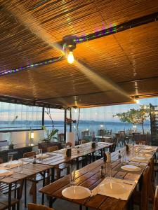 a row of tables in a restaurant with a view at Navarro Hotel in Caticlan