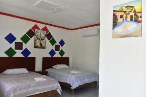 Postel nebo postele na pokoji v ubytování Hotel Bacaanda