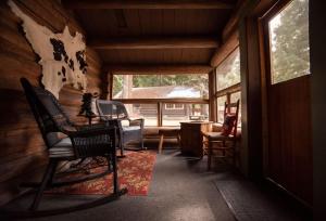 una habitación con sillas y una mesa en una cabaña en Lochsa Lodge en Lolo