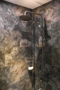 a shower with a glass door in a bathroom at Navarro Hotel in Caticlan