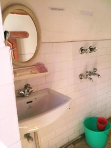 a bathroom with a sink and a mirror at Gomang guest house Leh in Leh