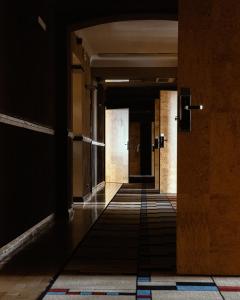 an empty corridor in an office building with a dark hallway at Hotel Monopol in Katowice