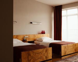 Posteľ alebo postele v izbe v ubytovaní Hotel Monopol