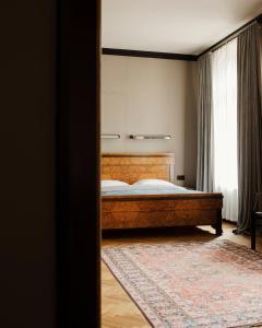 a bedroom with a bed and a large window at Hotel Monopol in Katowice